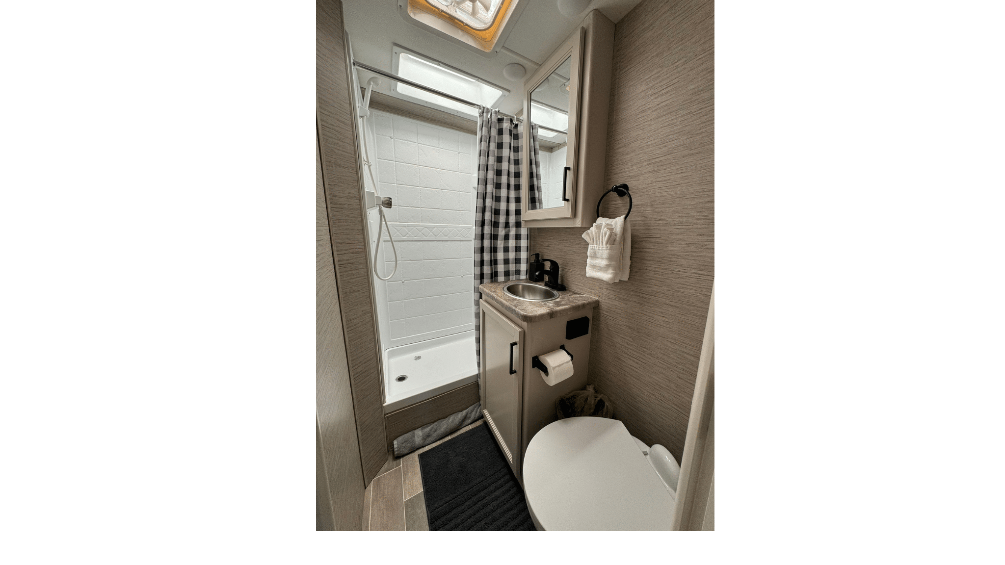 2022 Thor Chateau Roadrunner bathroom with shower, sink, toilet, includes towels, hand soap and toilet paper.