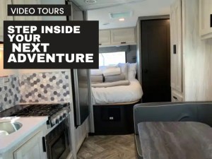 RV interior with queen bed stove and dinette